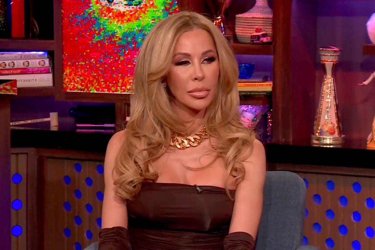 Lisa Hochstein wears black strapless dress and black gloves with gold necklace while appearing on WWHL 