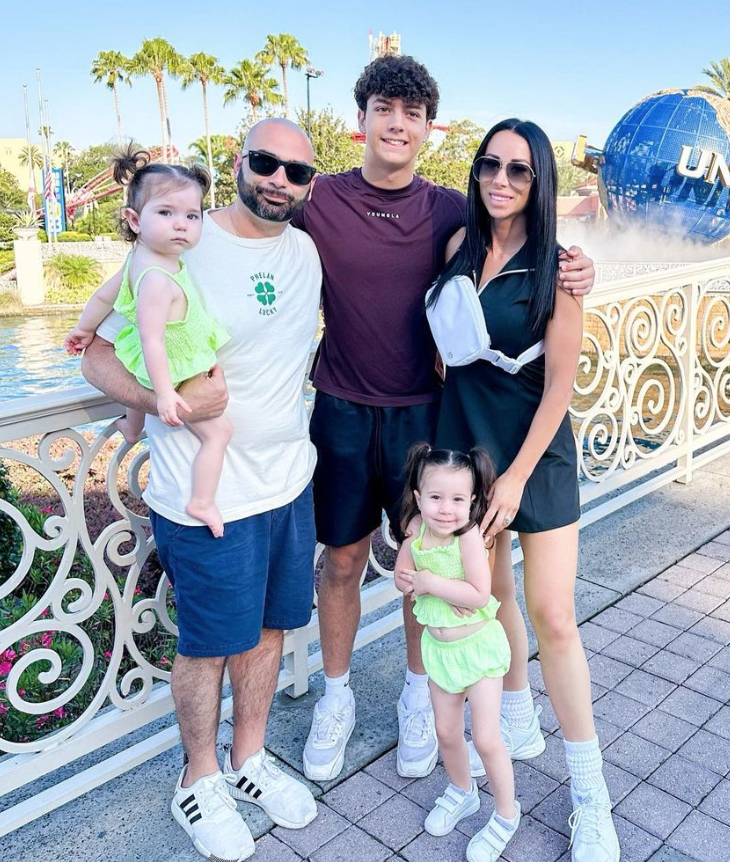 Rachel Fuda and John Fuda pose with the three children at Universal Studios