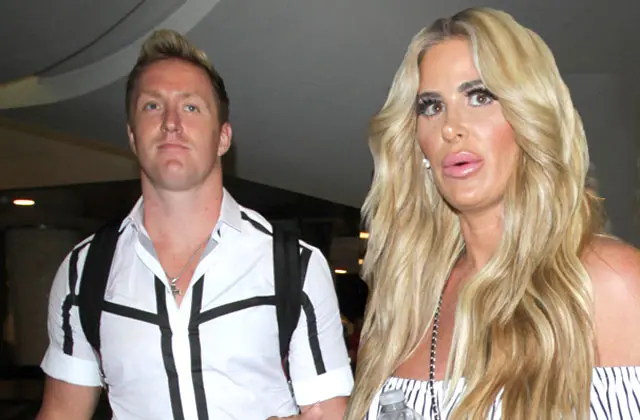 Kroy Biermann and Kim Zolciak staring appearing annoyed while being photographed.