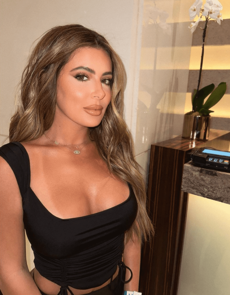 Brielle Biermann poses in low cut top while on vacation