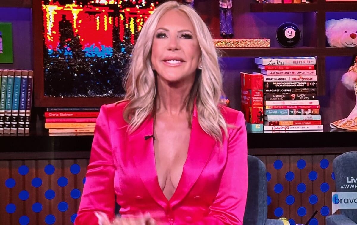 RHOC OG Vicki Gunvalson smiles happily on WWHL while wearing pink satin suit