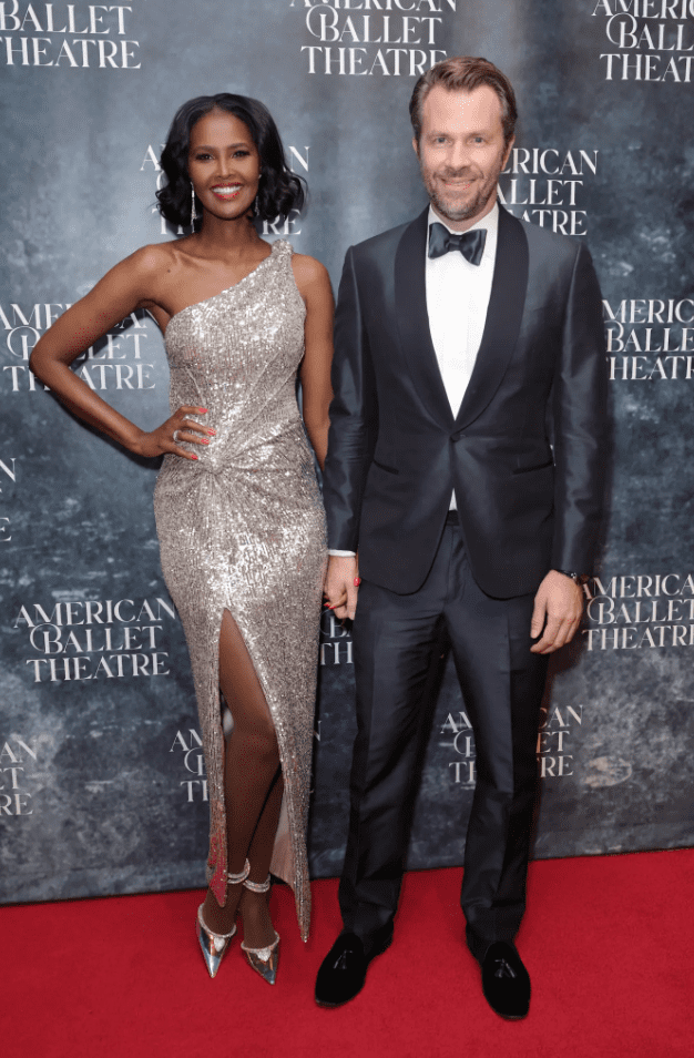 Ubah Hassan and Oliver Dachsel hold hands on the red carpet.