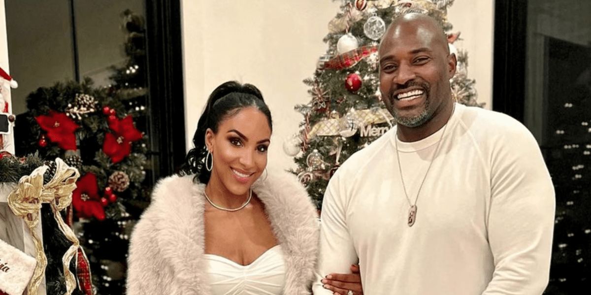 RHOBH newbie Annemarie Wiley and her husband former NFL star Marcellus Wiley pose for Christmas photo in fron of the tree